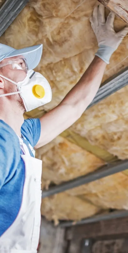 man inspecting house insulation Godley TX 517x1024 1